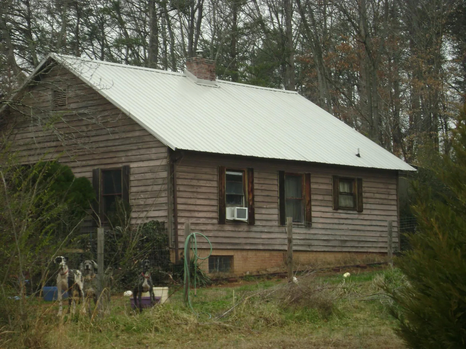 White metal roof on an old wood sided farmhouse, from a Metal Roof Installation job in Flint Hill